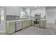 Stylish kitchen with sage green cabinets, stainless steel appliances, and a window over the sink at 4018 E Goldfinch Gate Ln, Phoenix, AZ 85044