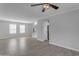 Open living room with tile flooring, ceiling fan, built-in shelving, and stairs at 4018 E Goldfinch Gate Ln, Phoenix, AZ 85044