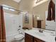 Clean bathroom with white bathtub, sink, and brown vanity at 6202 E Mckellips Rd # 66, Mesa, AZ 85215