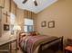 Well-lit bedroom with wooden furniture, floor lamp, and patterned bedding at 6202 E Mckellips Rd # 66, Mesa, AZ 85215
