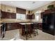 Kitchen with an island, dark wood cabinets, and stainless steel appliances at 6202 E Mckellips Rd # 66, Mesa, AZ 85215