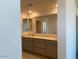 Modern bathroom featuring dual vanities, large mirror, and recessed lighting at 7460 E Hackamore Ln, San Tan Valley, AZ 85143