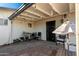 Covered patio with string lights, seating, and a stone floor at 906 W Danbury Rd, Phoenix, AZ 85023