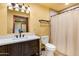 Bathroom with vanity sink, toilet, and shower with dark wood cabinets and light countertops at 9340 W Paseo Verde Dr, Casa Grande, AZ 85194