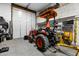 Garage space with a tractor, tools, and storage at 9340 W Paseo Verde Dr, Casa Grande, AZ 85194