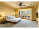 Main bedroom with a ceiling fan, carpeting, large windows, and mountain views at 9340 W Paseo Verde Dr, Casa Grande, AZ 85194