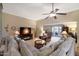 Living room with plush carpet, ceiling fan, fireplace, and access to backyard at 11006 W Topaz Dr, Sun City, AZ 85351