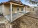 Covered patio and backyard with dirt landscaping at 11417 W Amber Trl, Surprise, AZ 85378