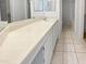 Bathroom with tile countertops, large mirror, and neutral color scheme at 11444 N 28Th Dr # 13, Phoenix, AZ 85029