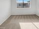 Empty bedroom with plush carpet and a large window providing natural light at 11444 N 28Th Dr # 13, Phoenix, AZ 85029