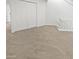 Carpeted bedroom with white closet doors and a staircase railing at 11444 N 28Th Dr # 13, Phoenix, AZ 85029