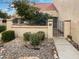 Private front courtyard with gate, lush landscaping, and orange tree at 11444 N 28Th Dr # 13, Phoenix, AZ 85029
