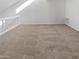 Open loft area with plush carpeting and a railing overlooking the lower level at 11444 N 28Th Dr # 13, Phoenix, AZ 85029