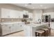 Modern kitchen featuring white shaker cabinets, stainless steel appliances, and an island with sink at 118 W Bahamas Dr, Casa Grande, AZ 85122