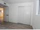 Bright bedroom with sliding closet doors and wood-look flooring at 11805 N 31St Ave, Phoenix, AZ 85029