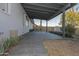 Covered patio area with a gray tiled floor and a view of the backyard and storage shed at 11805 N 31St Ave, Phoenix, AZ 85029