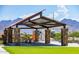 Shaded picnic area with stone pillars and mountain views in background at 12639 W Parkway Ln, Avondale, AZ 85323