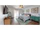 Bedroom featuring wood floors, a ceiling fan, teal accents, and access to a balcony at 14959 S 184Th Ave, Goodyear, AZ 85338