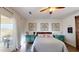 Bedroom featuring wood floors, sliding barn door and balcony access at 14959 S 184Th Ave, Goodyear, AZ 85338