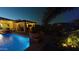 Tranquil backyard pool with water feature, lush landscaping, and lighting at 14959 S 184Th Ave, Goodyear, AZ 85338