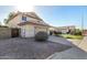 Side view of a two-story house featuring an attached garage, tile roof, and a fenced yard at 1611 W Cindy St, Chandler, AZ 85224