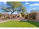 Private backyard with a built-in fireplace and artificial turf lawn at 1613 W Ainsworth Dr, Anthem, AZ 85086
