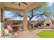 Spacious backyard with covered patio, built-in grill, fireplace, and lush lawn at 1613 W Ainsworth Dr, Anthem, AZ 85086