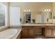 Bathroom with dual sinks, soaking tub, and separate shower at 1613 W Ainsworth Dr, Anthem, AZ 85086
