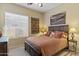 Cozy bedroom with wooden furniture and large window with blinds at 1613 W Ainsworth Dr, Anthem, AZ 85086