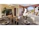 Dining area with a table set for a dinner party and view of the living room at 1613 W Ainsworth Dr, Anthem, AZ 85086