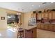 Kitchen with island, breakfast bar, stainless steel appliances, and sliding glass door to the backyard at 1613 W Ainsworth Dr, Anthem, AZ 85086