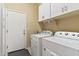 Laundry room with white cabinets, washer, and dryer at 1613 W Ainsworth Dr, Anthem, AZ 85086