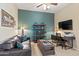 Home office or den with desk, couch, and shelving at 1613 W Ainsworth Dr, Anthem, AZ 85086