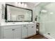 Modern bathroom featuring dual vanities, a glass shower, and sleek fixtures at 17850 W Villa Chula Ln, Surprise, AZ 85387