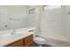 Bathroom with wood vanity, white tub/shower combo, and linoleum flooring at 18429 E Swan Dr, Queen Creek, AZ 85142