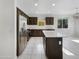 Kitchen with island, stainless steel appliances, and dark wood cabinetry at 19724 N Lief Rd, Maricopa, AZ 85138