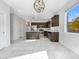 Modern kitchen featuring dark wood cabinets, stainless steel appliances, and an island at 19724 N Lief Rd, Maricopa, AZ 85138