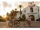 Couple biking past local shops and the Main Street Market in the community at 20224 W Roma Ave, Litchfield Park, AZ 85340