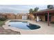 Kidney shaped swimming pool in backyard with covered patio at 3630 N 86Th Ave, Phoenix, AZ 85037