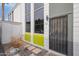 Front exterior of the home with a security door, green accent wall, and a storage shed at 385 W Pierson St # C2, Phoenix, AZ 85013