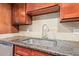 Close-up of the granite countertops, stainless steel sink, and tile backsplash at 385 W Pierson St # C2, Phoenix, AZ 85013