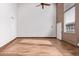 Bright living room with wood-look tile flooring, a wood accent wall, and entry door access at 385 W Pierson St # C2, Phoenix, AZ 85013