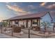 Gated front yard with a variety of desert plants, rustic metal planters, and a walkway leading to the home at 4450 Black Mountain Rd, Wickenburg, AZ 85390