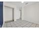 Bedroom with tile flooring, closet and blue accent wall at 7221 W Caron Dr, Peoria, AZ 85345