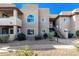 Exterior view of a two-story condo building with a staircase, landscaping, and a walkway at 9451 E Becker Ln # 1026, Scottsdale, AZ 85260