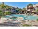 Community pool with hot tub, lounge chairs, and shaded seating area at 9451 E Becker Ln # 1026, Scottsdale, AZ 85260