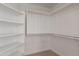 Walk-in closet with ample built-in shelving and hanging rods at 9902 E Meseto Ave, Mesa, AZ 85209