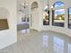 Open dining area with tile flooring, view of staircase, and front entryway at 10721 W Laurelwood Ln, Avondale, AZ 85392