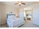 Guest bedroom with neutral decor, ceiling fan, and access to an attached living space at 1365 E Avenida Ellena Ln, Casa Grande, AZ 85122