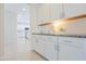 White kitchen cabinets with sleek hardware and a countertop area at 1365 E Avenida Ellena Ln, Casa Grande, AZ 85122